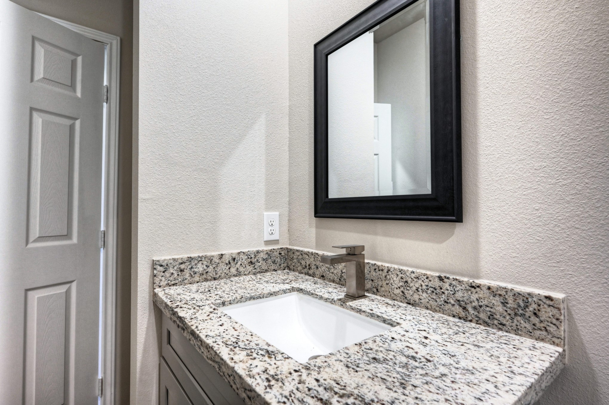 9173 Inwood Willis, TX 77318 - Photo 12 of 31 a bathroom with a granite countertop sink and a mirror