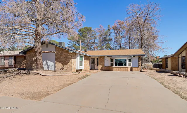 a front view of a building with a yard