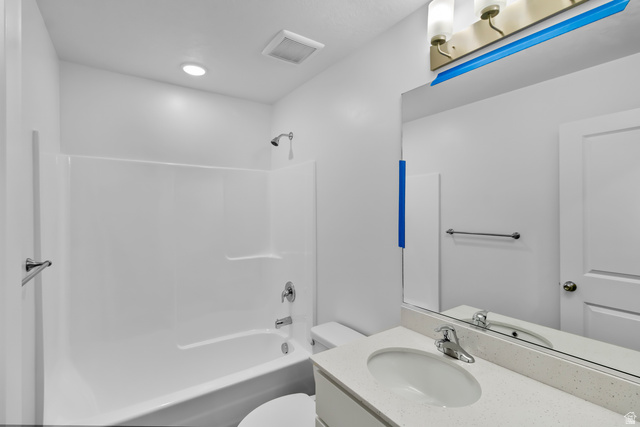 3014 South 265th Street West Logan, UT 84321 - Photo 15 of 25 Bathroom featuring a tub/shower combination with a single-handle faucet and shower head, a single vanity with a white countertop and oval sink, a chrome faucet, and a large wall-mounted mirror