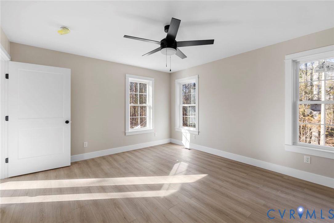 320 Vogel Road Cumberland, VA 23040 - Photo 14 of 27 a view of an empty room with wooden floor and a window