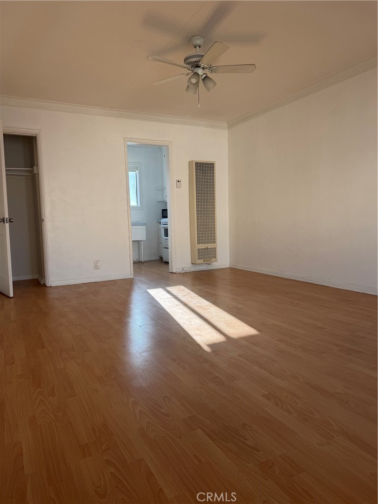 209 South Reeves Drive Beverly Hills, CA 90212 - Photo 3 of 14 a view of a room with wooden floor and ceiling fan