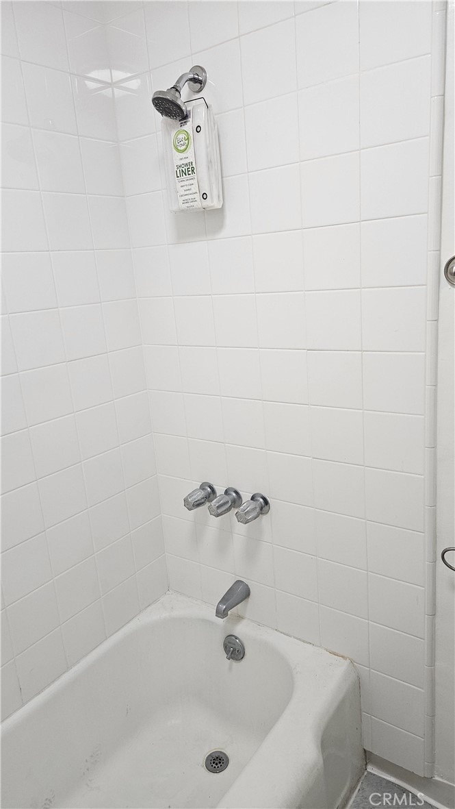 209 South Reeves Drive Beverly Hills, CA 90212 - Photo 3 of 8 a white bath tub sitting in a bathroom