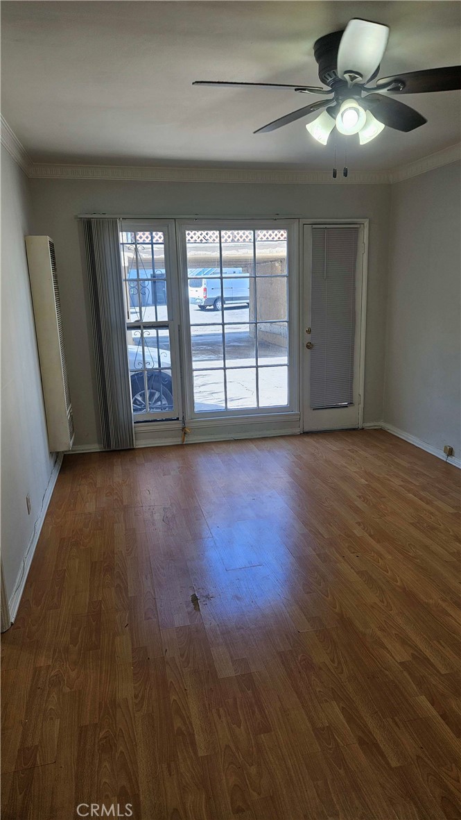 209 South Reeves Drive Beverly Hills, CA 90212 - Photo 6 of 8 a view of an empty room with glass door and windows