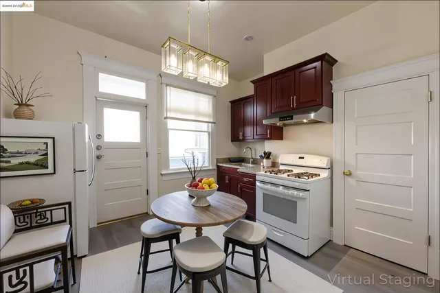 a kitchen with stainless steel appliances white cabinets and a stove top oven