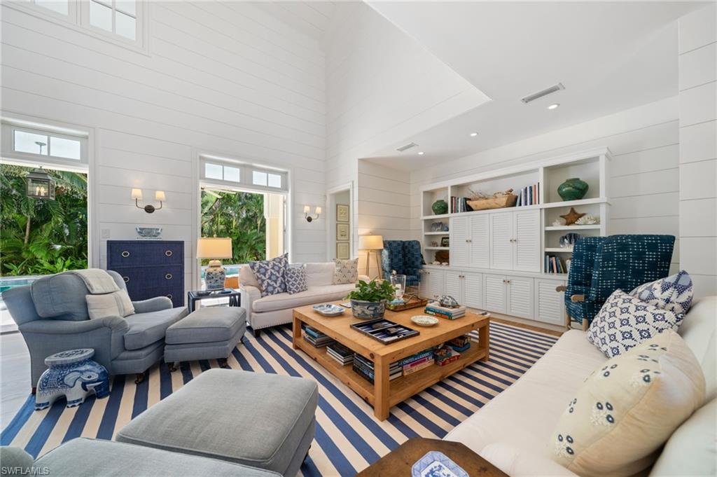 390 Windward Way Naples, FL 34103 - Photo 11 of 42 a living room with furniture a rug and a table