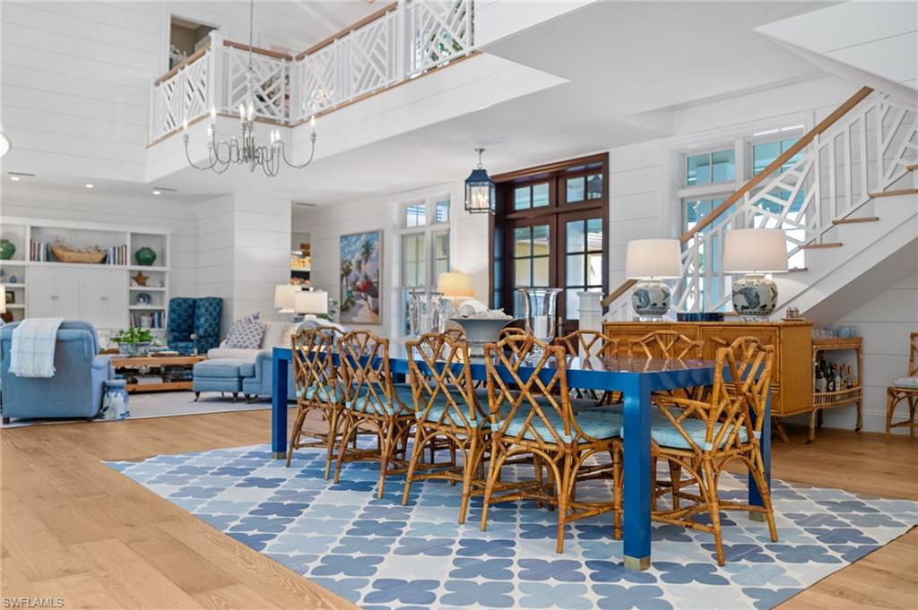 390 Windward Way Naples, FL 34103 - Photo 13 of 42 a living room with lots of furniture and a chandelier