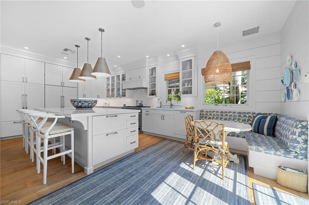 390 Windward Way Naples, FL 34103 - Photo 17 of 42 a kitchen with a sink cabinets and window
