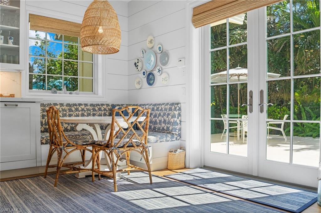 390 Windward Way Naples, FL 34103 - Photo 20 of 42 a view of a dining room with furniture wooden floor and a chandelier