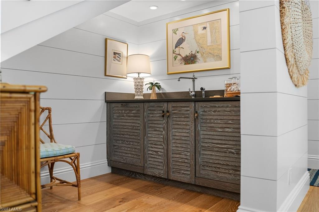 390 Windward Way Naples, FL 34103 - Photo 26 of 42 a bathroom with a sink and a mirror