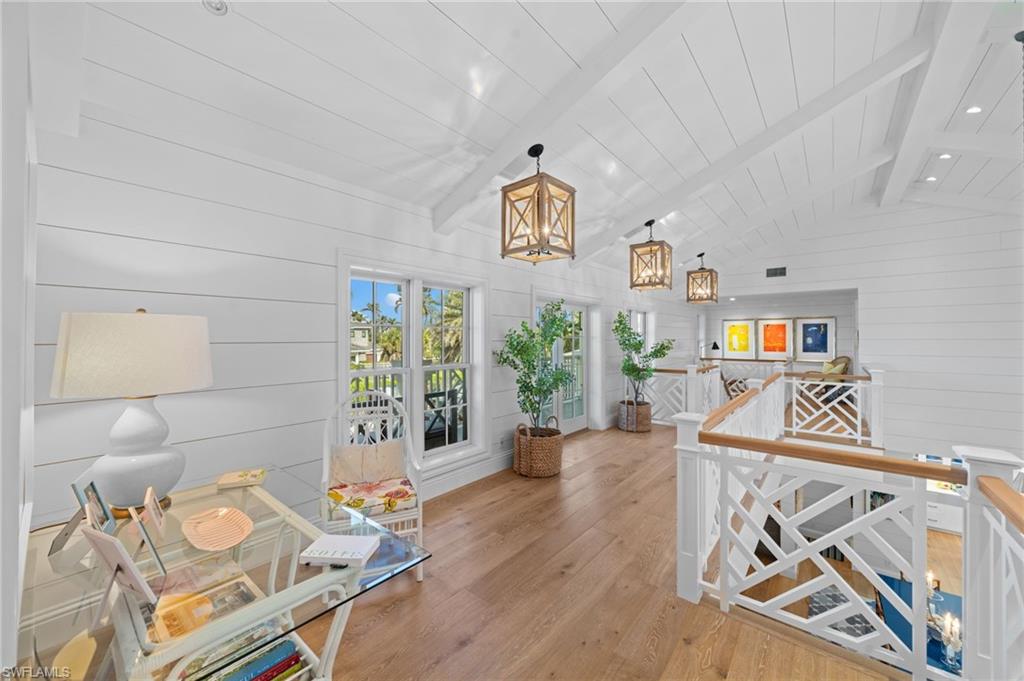 390 Windward Way Naples, FL 34103 - Photo 27 of 42 a living room with furniture and a chandelier