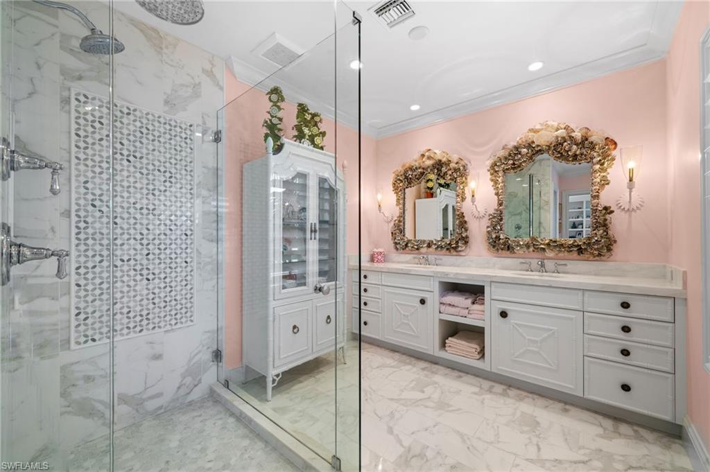 390 Windward Way Naples, FL 34103 - Photo 29 of 42 a bathroom with a granite countertop sink a mirror and a shower