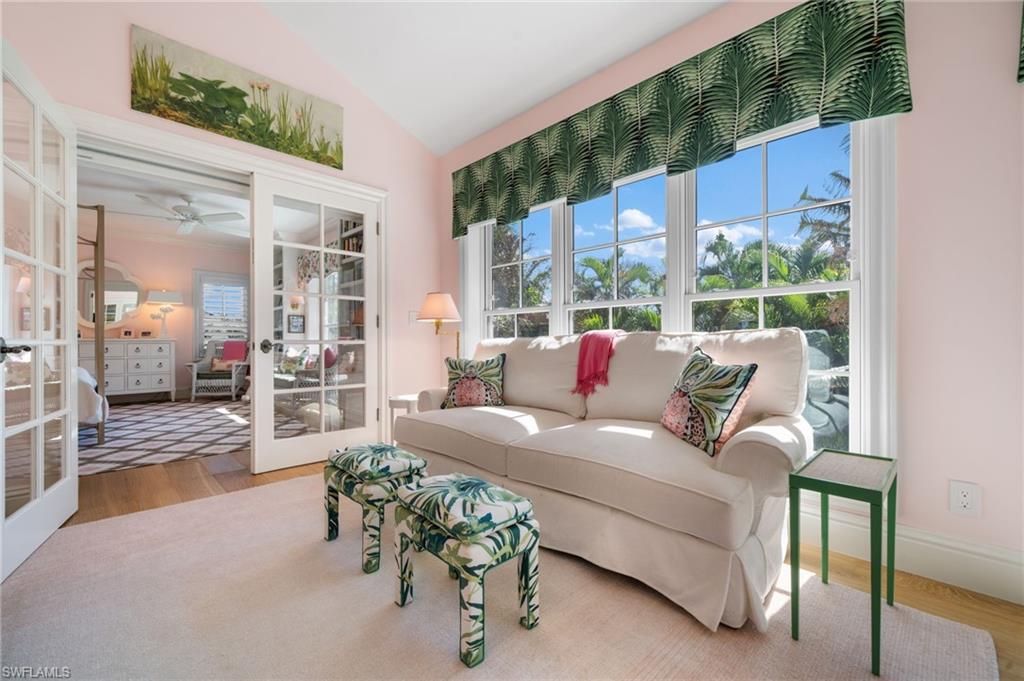 390 Windward Way Naples, FL 34103 - Photo 30 of 42 a living room with furniture and a large window