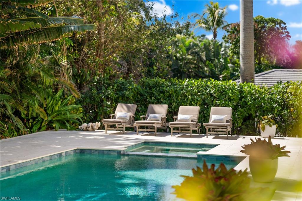 390 Windward Way Naples, FL 34103 - Photo 5 of 42 a view of a lake with sitting area