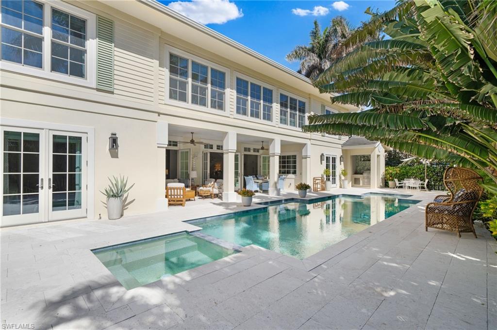 390 Windward Way Naples, FL 34103 - Photo 8 of 42 a view of a house with swimming pool in front of it