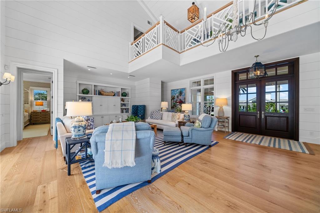 390 Windward Way Naples, FL 34103 - Photo 9 of 42 a living room with furniture and wooden floor