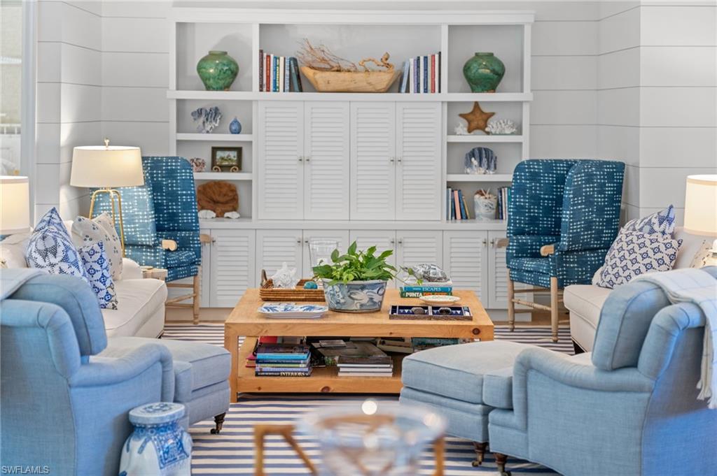 390 Windward Way Naples, FL 34103 - Photo 10 of 42 a living room with furniture and a couch