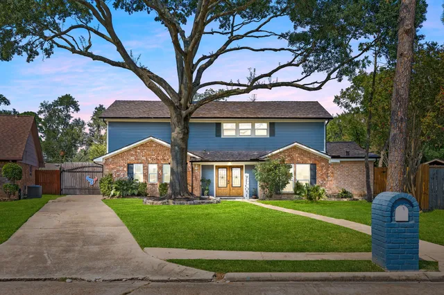 a front view of a house with a garden and plants