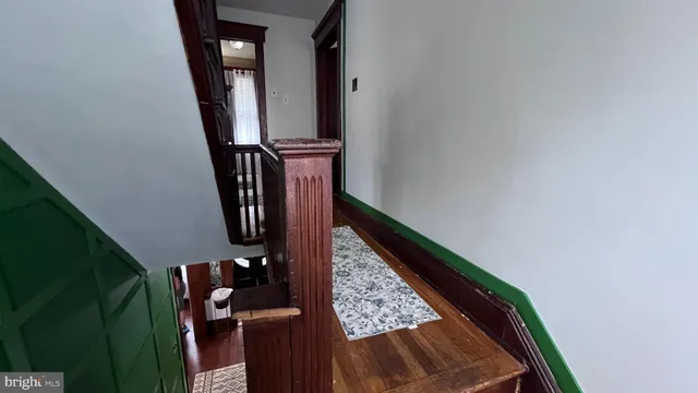 a view of staircase with wooden floor