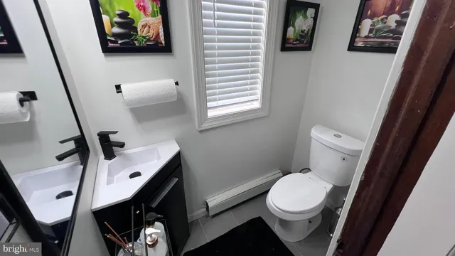 a bathroom with a toilet a sink and a window