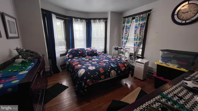 a bedroom with a bed flowerpot and window