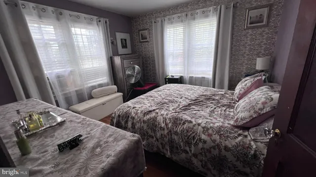 a view of a hallway with wooden floor and furniture