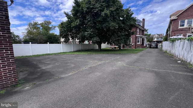 a view of a house with a large window and brick walls