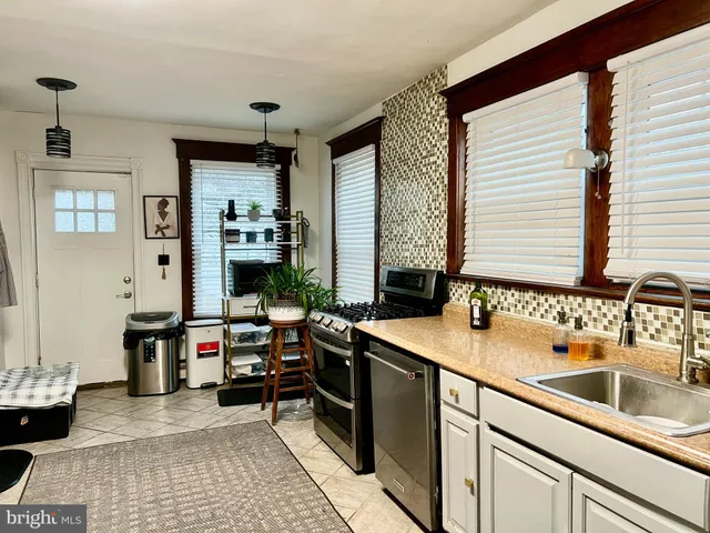 a kitchen with a sink and large window