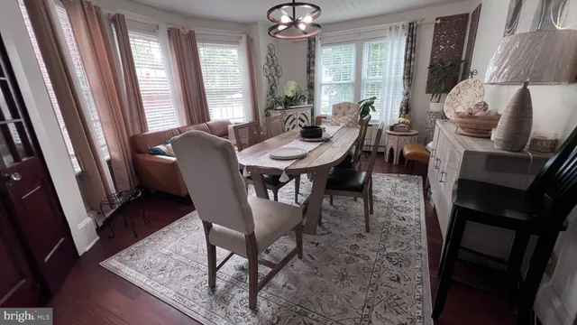a view of a dining room with furniture window and wooden floor