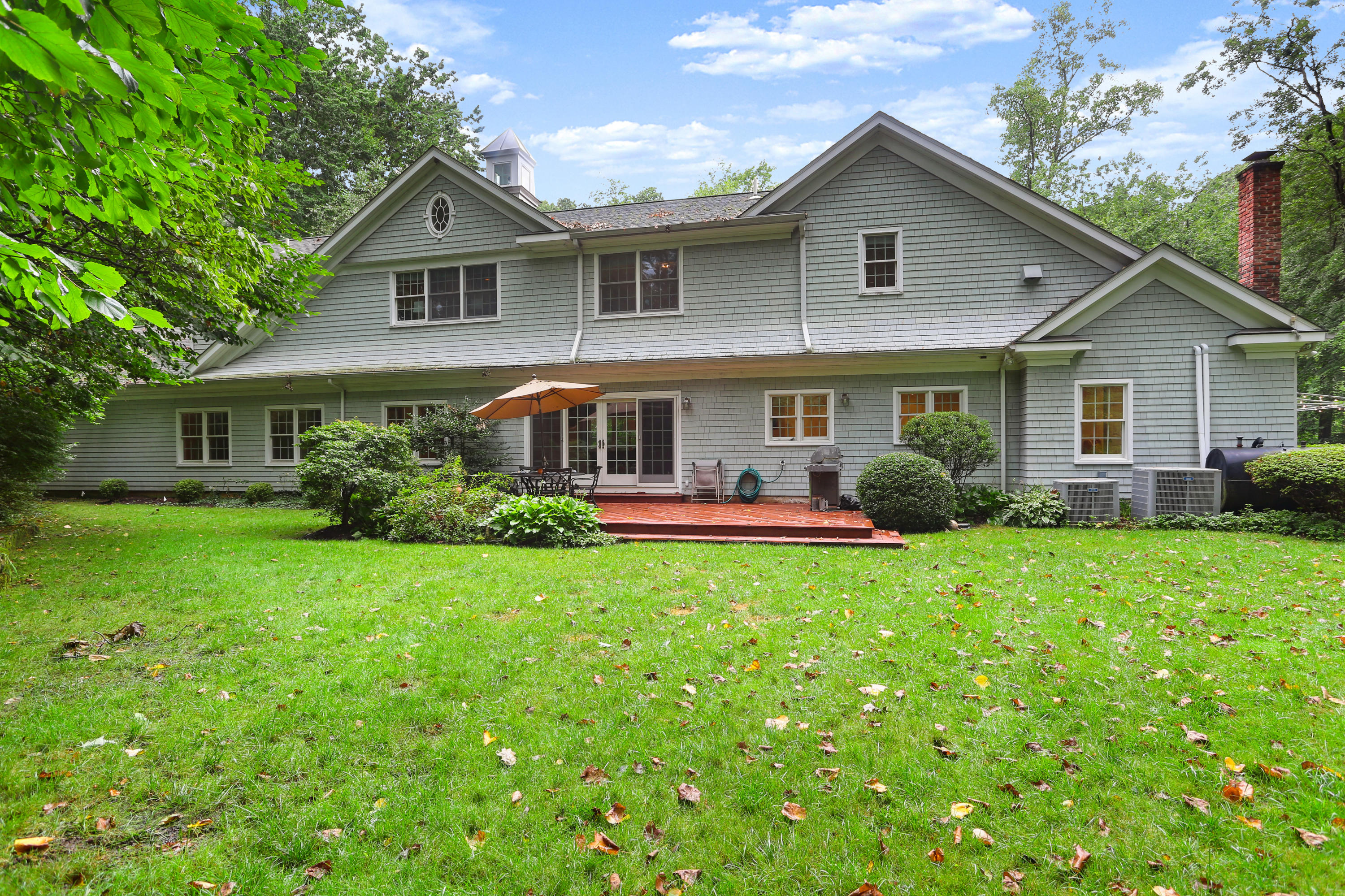 5 Stony Brook Road South Darien, CT 06820 - Photo 2 of 27 a front view of a house with garden