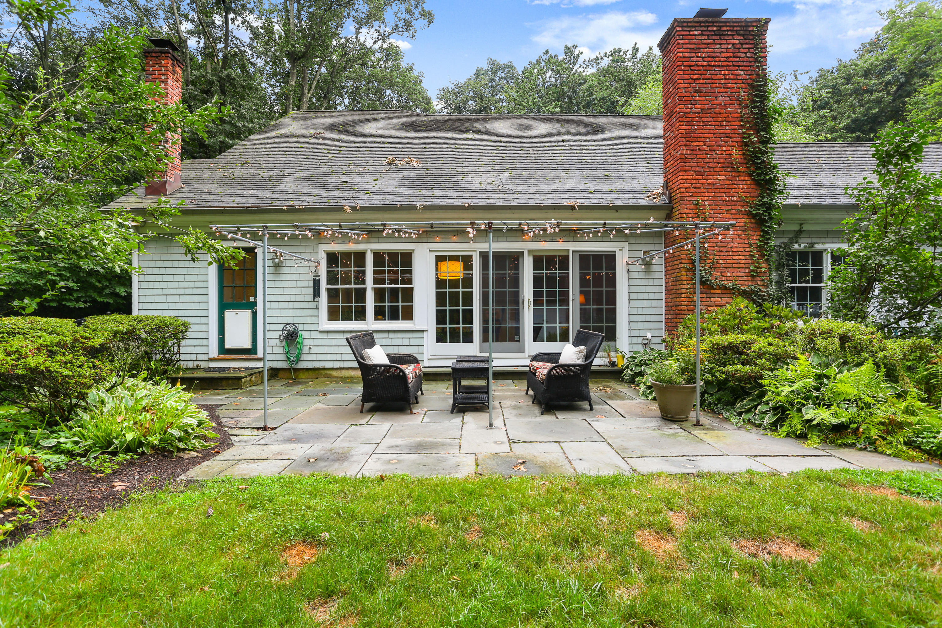 5 Stony Brook Road South Darien, CT 06820 - Photo 22 of 27 front view of a house with a yard outdoor seating and a garden