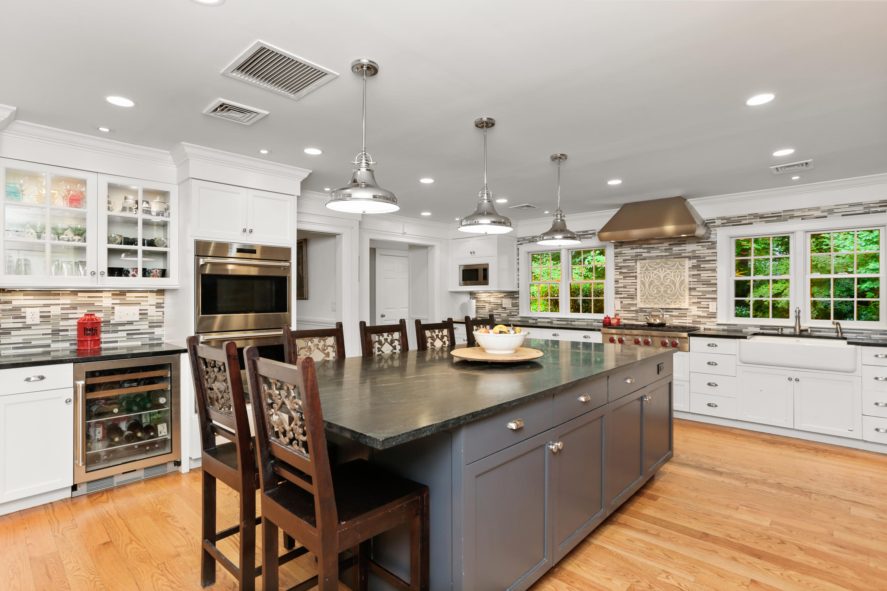 5 Stony Brook Road South Darien, CT 06820 - Photo 9 of 27 a kitchen with stainless steel appliances granite countertop a sink a stove a dining table and chairs