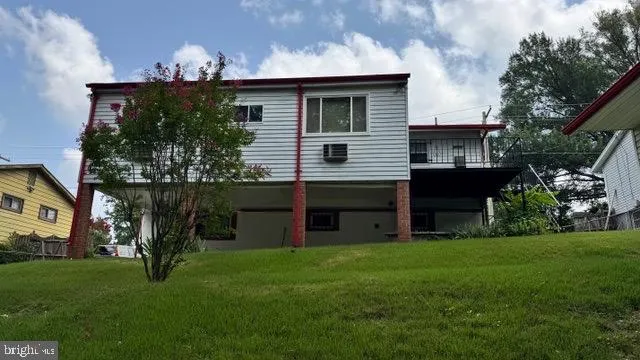 a front view of house with yard and outdoor seating