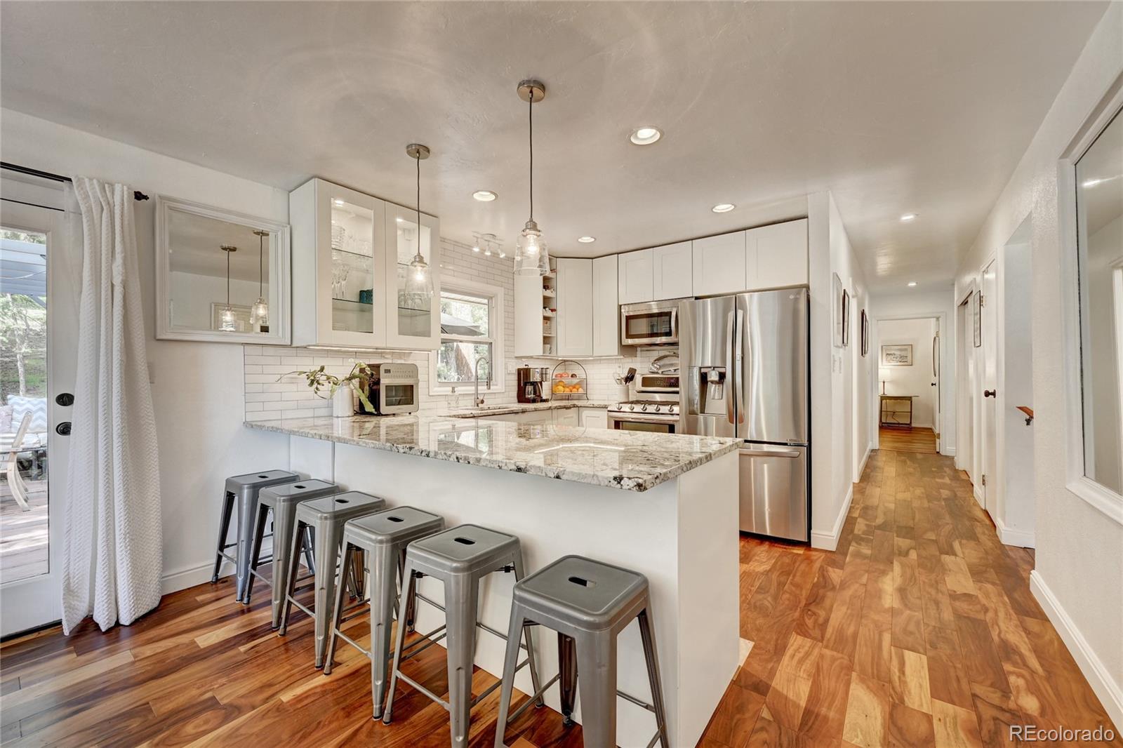 a kitchen with stainless steel appliances a refrigerator and a stove top oven