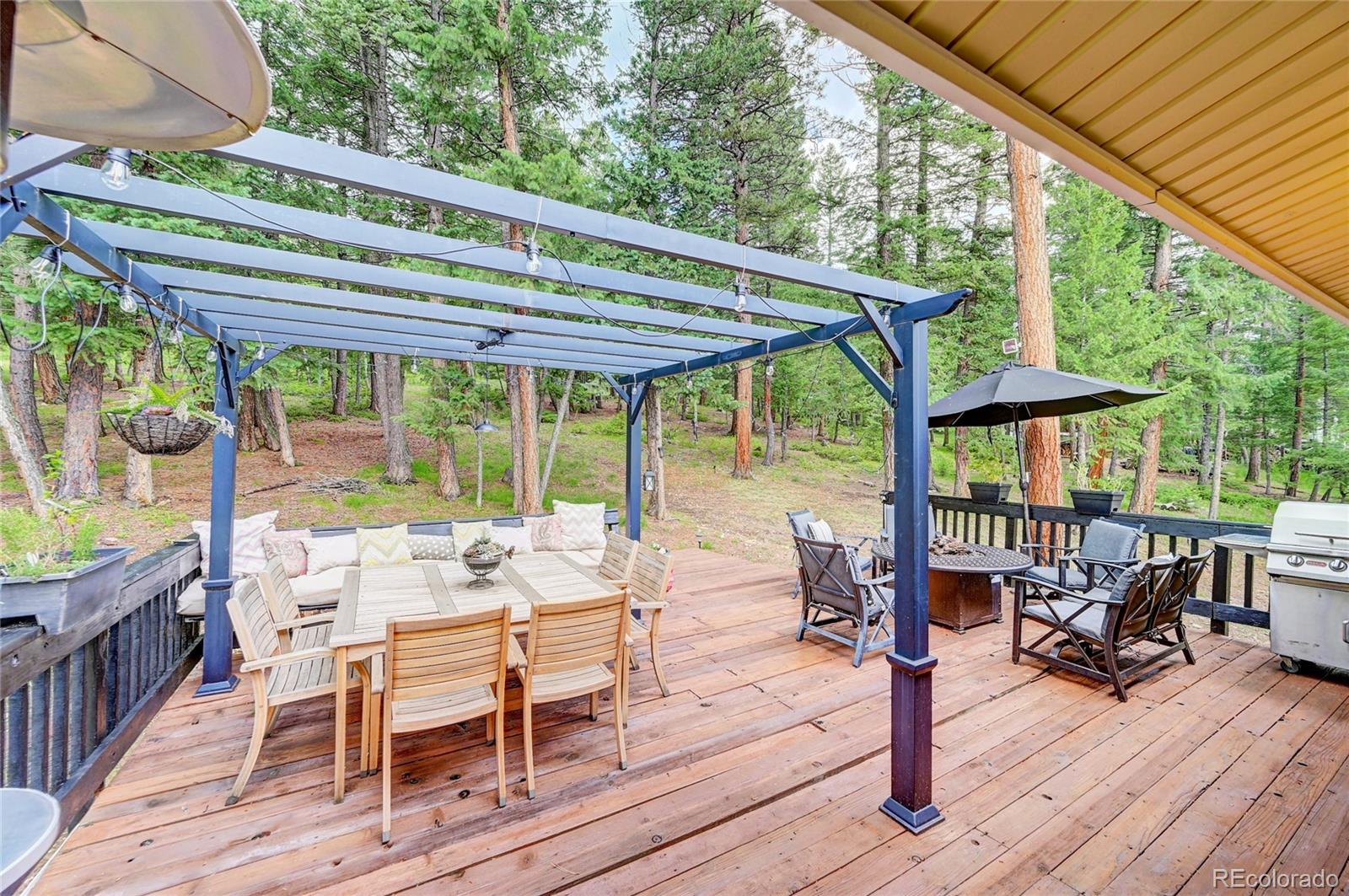 6549 Modoc Lane Evergreen, CO 80439 - Photo 12 of 39 a view of a patio with a table chairs and wooden floor