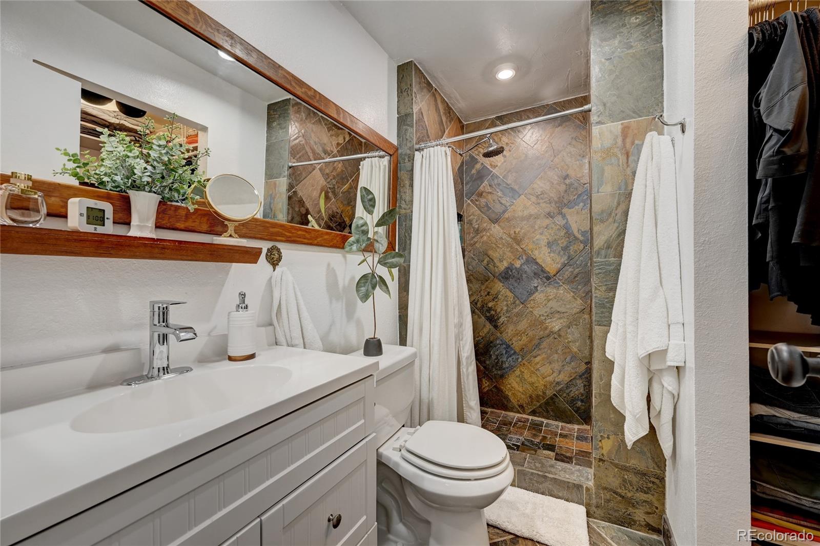 6549 Modoc Lane Evergreen, CO 80439 - Photo 16 of 39 a bathroom with a sink toilet and shower