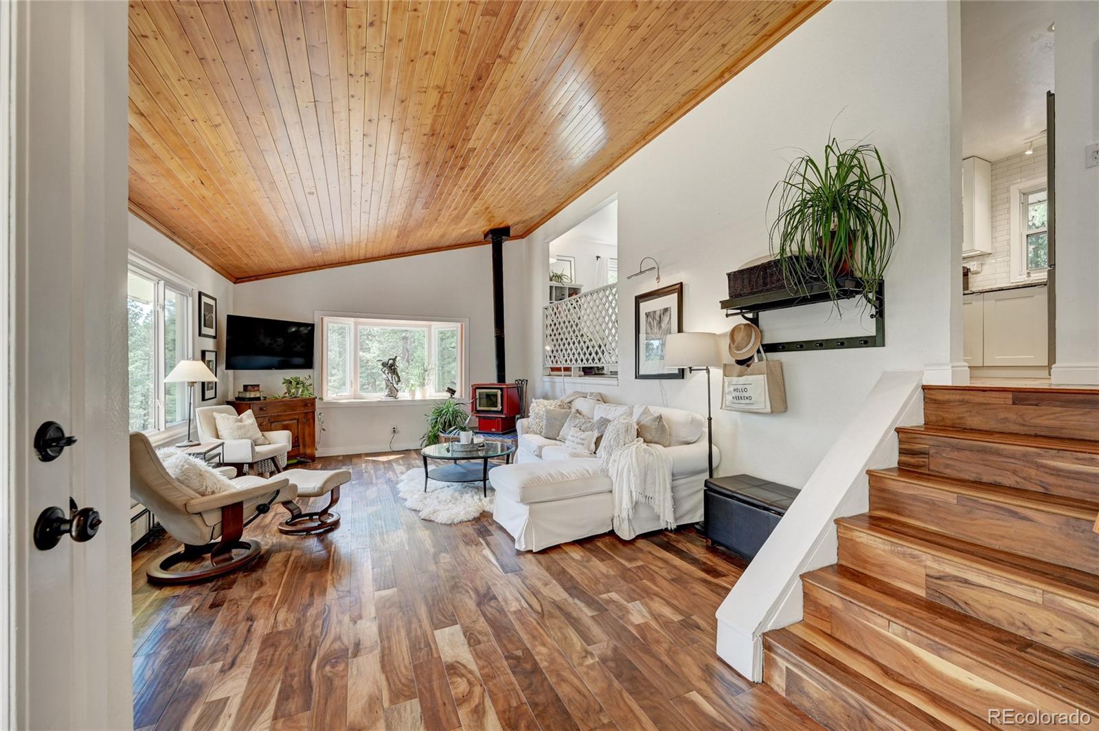 6549 Modoc Lane Evergreen, CO 80439 - Photo 2 of 39 a living room with furniture and a wooden floor