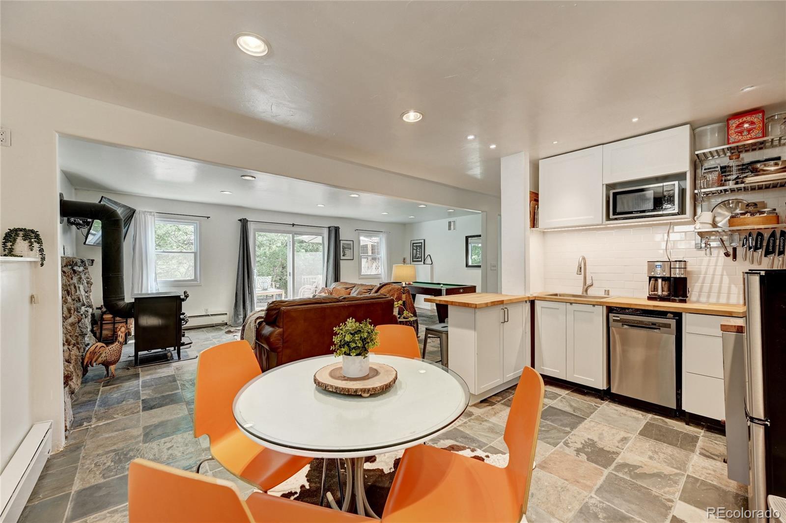 6549 Modoc Lane Evergreen, CO 80439 - Photo 21 of 39 a dining room with furniture and wooden floor