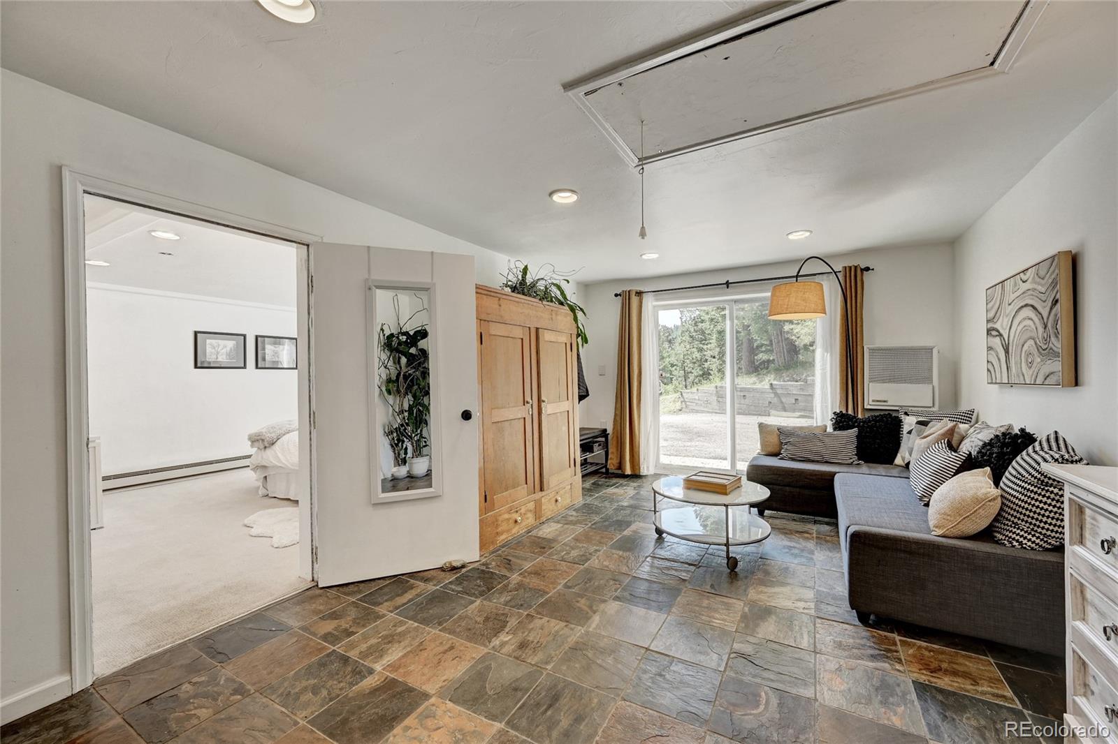 6549 Modoc Lane Evergreen, CO 80439 - Photo 27 of 39 a living room with furniture and large windows