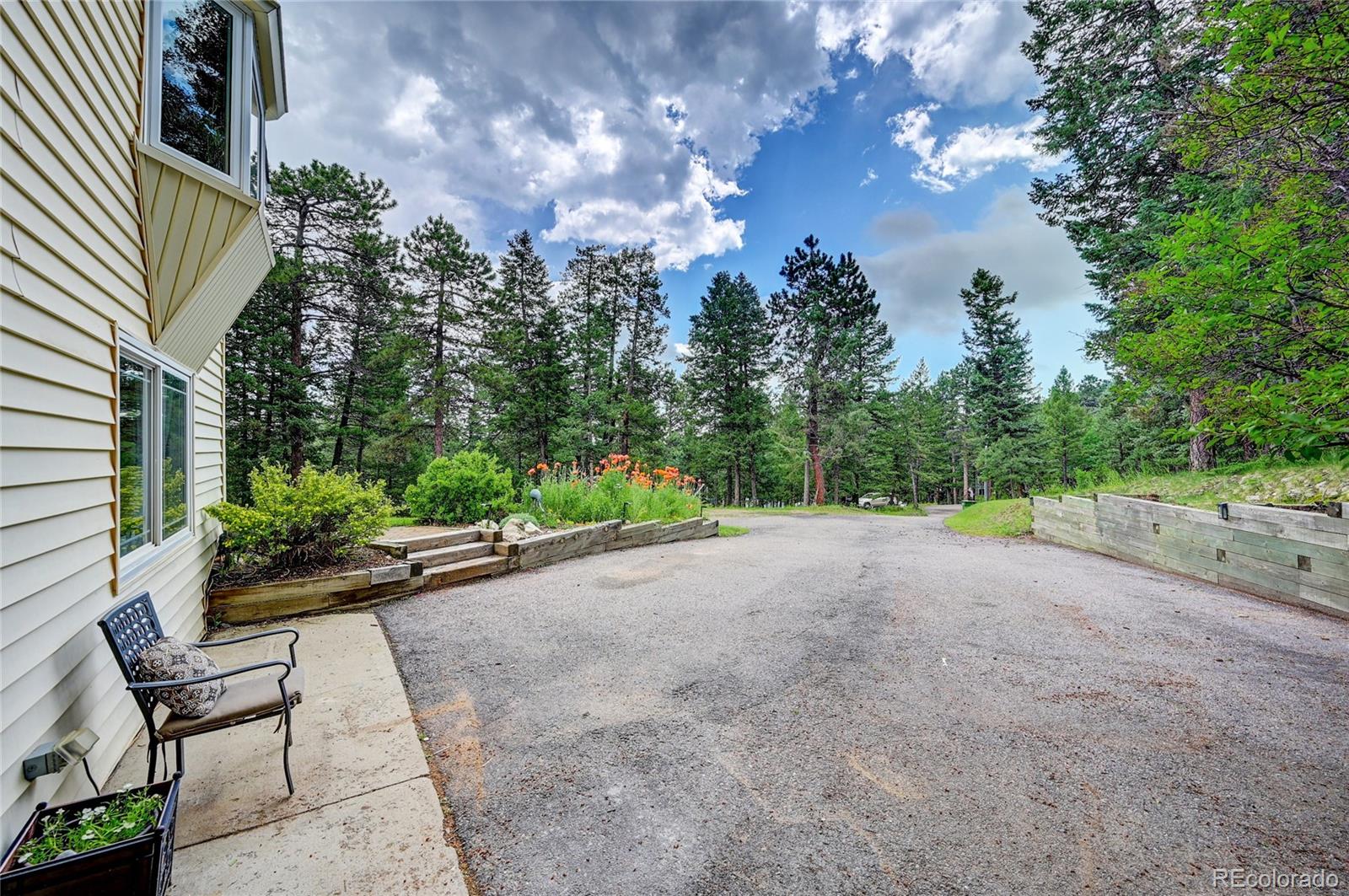 6549 Modoc Lane Evergreen, CO 80439 - Photo 32 of 39 a view of a garden with sitting area