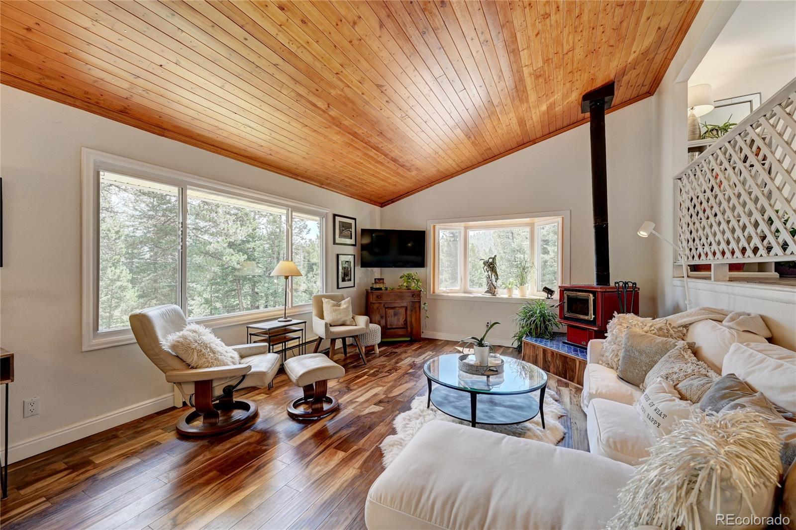 6549 Modoc Lane Evergreen, CO 80439 - Photo 6 of 39 a living room with furniture and large windows