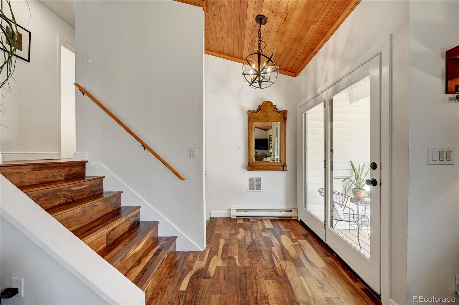 6549 Modoc Lane Evergreen, CO 80439 - Photo 7 of 39 a view of entryway and hall with wooden floor