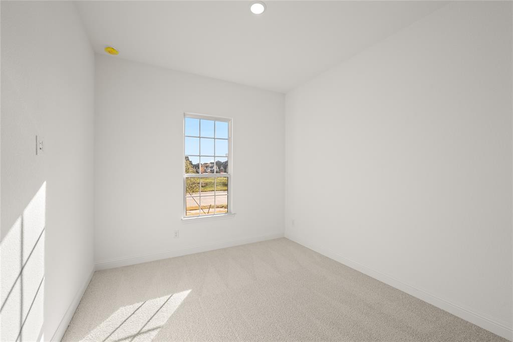 1016 Mill Ridge Drive Justin, TX 76247 - Photo 13 of 28 a view of an empty room with a window