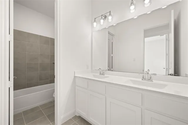 a bathroom with a double vanity sink and a mirror
