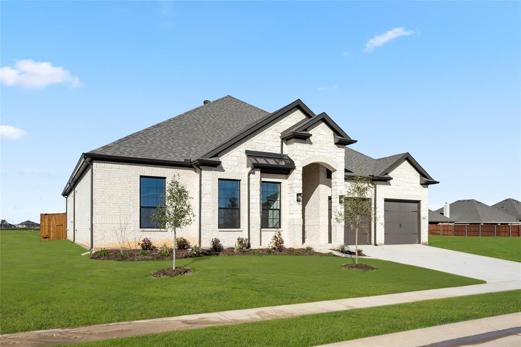 1016 Mill Ridge Drive Justin, TX 76247 - Photo 2 of 28 a front view of a house with a yard