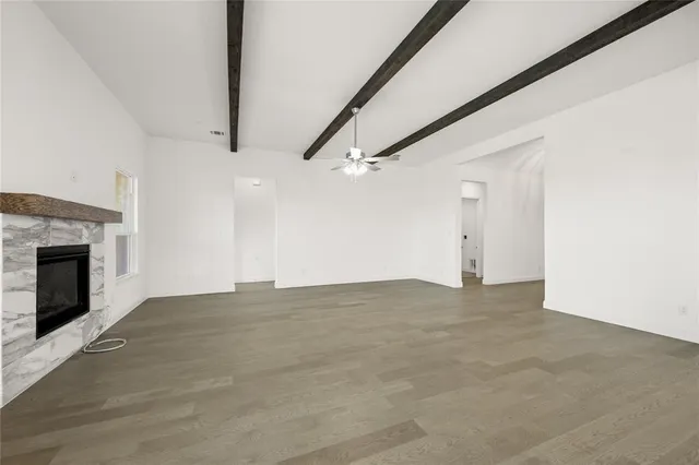 a view of an empty room with a fireplace