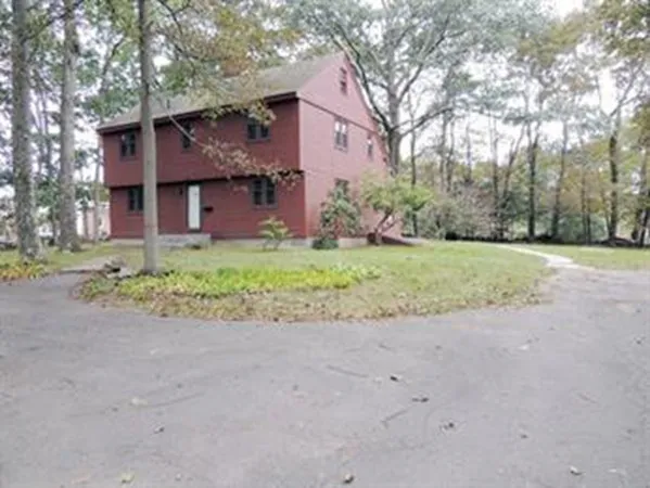 a front view of a house with a garden and yard
