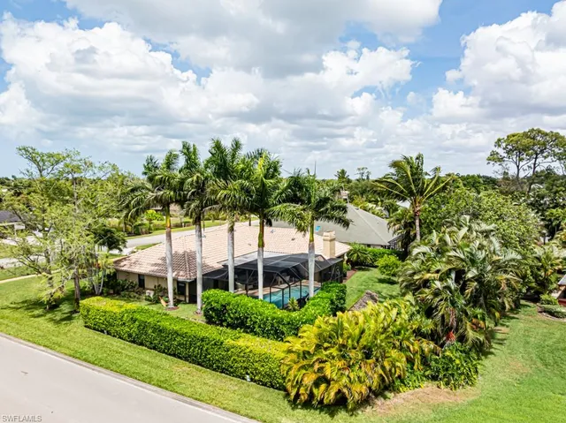 a view of a garden with a building in the background