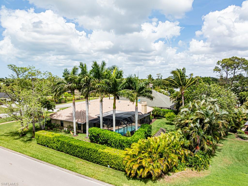 a view of a garden with a building in the background