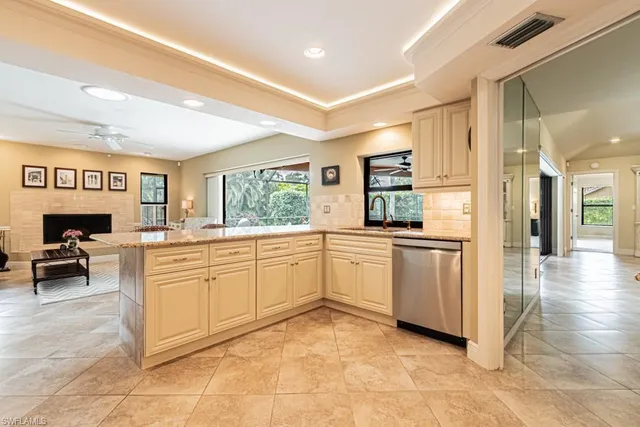 a kitchen with granite countertop cabinets and a view of living room
