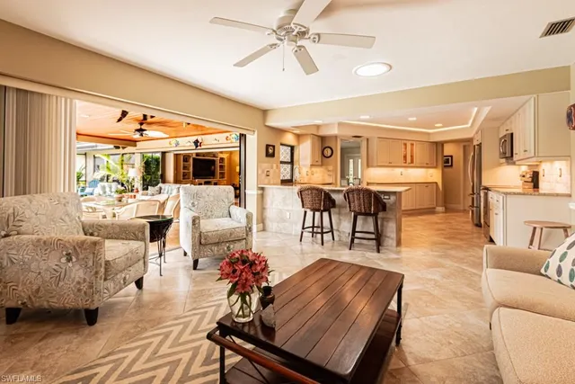 a living room with furniture and view of kitchen